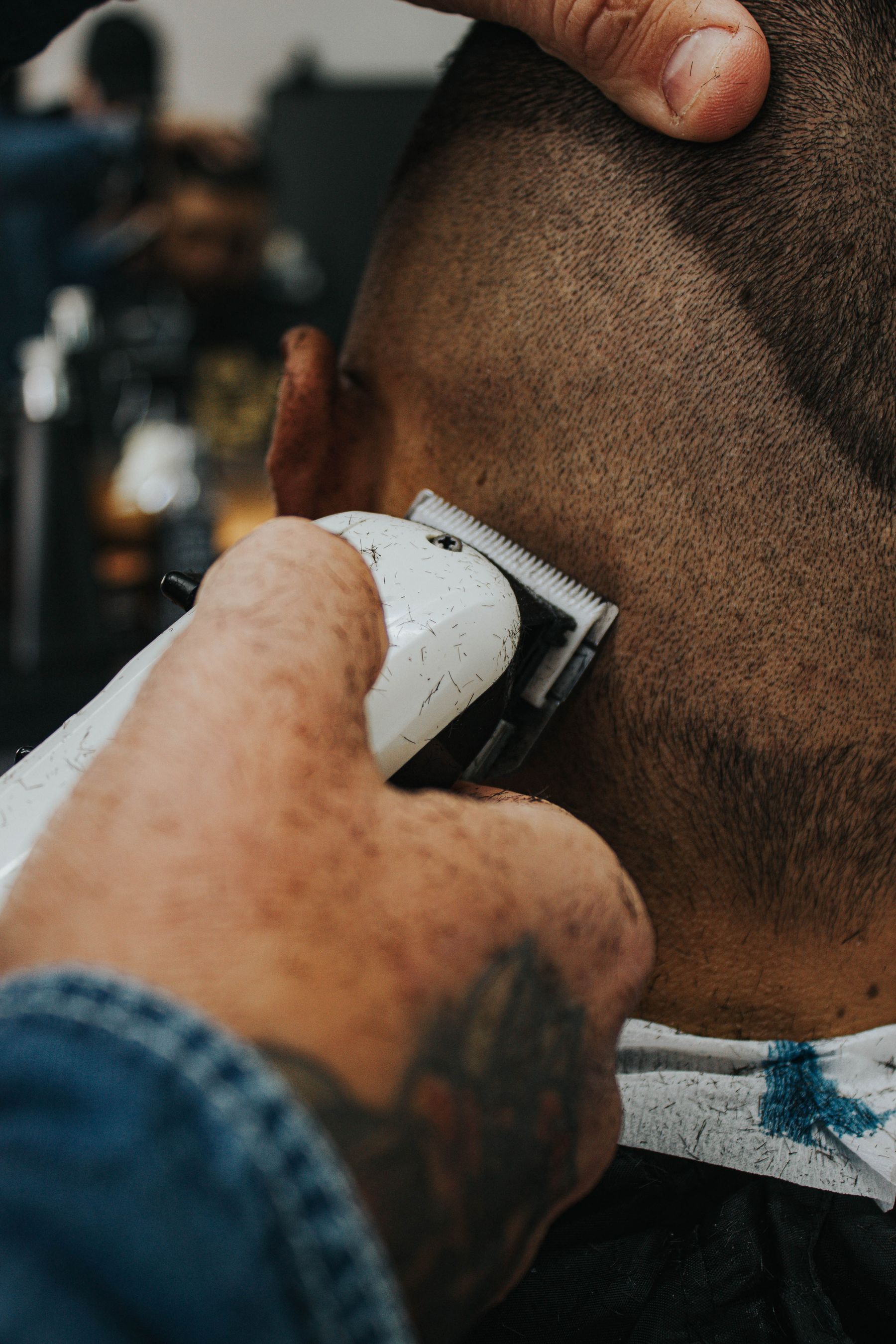 Close-up of clippers on a client's head